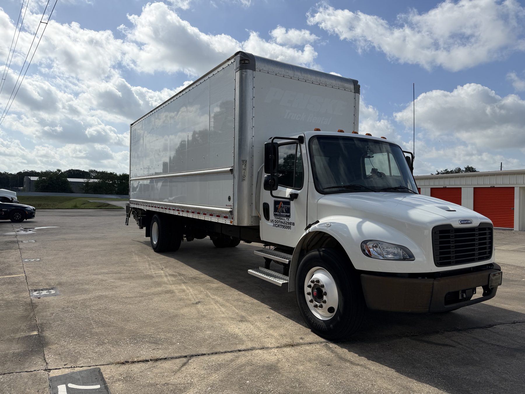 Alinea Transport 2023 Freightliner M2 26-foot box truck, front three-quarter view, plated and DOT-marked